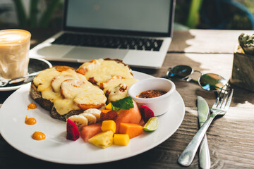 Appetizing  breakfast with coffee and laptop