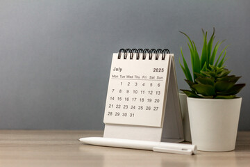 Hello July. July 2025 Planning Calendar on your desk.