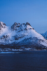 Norway fjord with snowy peaks near water