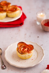 Apple roses Puff pastry sprinkled with red dry powdered strawberry. Romantic Dessert for Valentine's Day or Birthday. Twisted cake. Food photography and styling.
