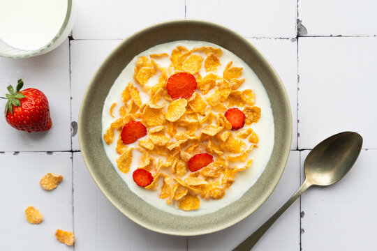 Delicious breakfast with cornflakes, milk, and fresh strawberries - Powered by Adobe