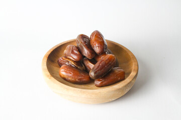 Date fruit, kurma Tunisia on small bowl on isolated white background.
