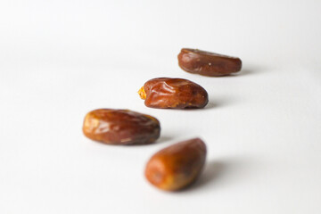 Date fruit, kurma Tunisia on small bowl on isolated white background.
