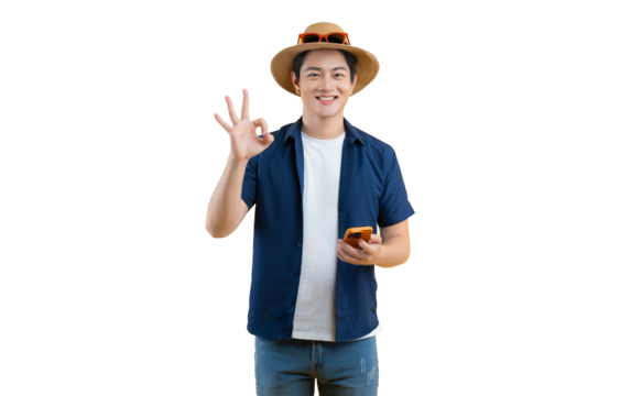 Portrait of young Asian man wearing tourist clothes and using phone on yellow background - Powered by Adobe