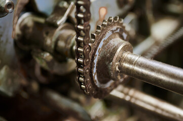 Intricate gears and components of a vintage machine showcasing industrial craftsmanship in a rustic workshop setting