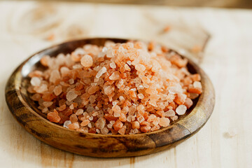 Himalayan pink salt on a wooden plate