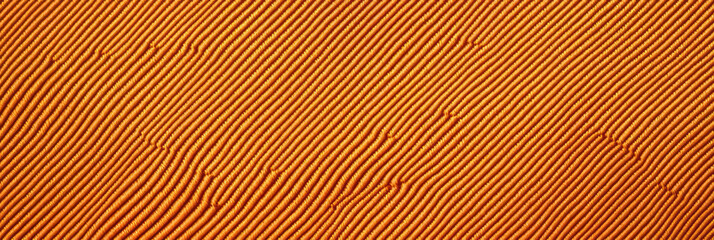 Fototapeta premium Bright amber cotton fabric showcasing a twill weave with diagonal pattern for creative projects