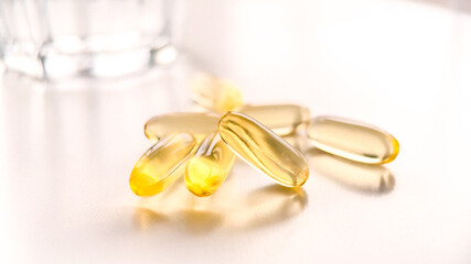 Capsules of Golden fish oil. Nutritional supplements for good health on a white background....