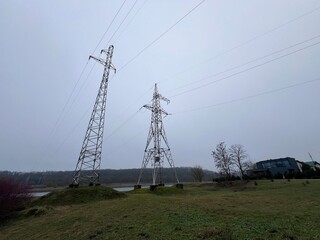 High voltage electricity tower landscape at sunset it lithuania, winter cloudy