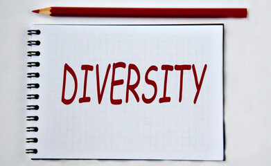 DIVERSITY - word in notebook on white background with pencils