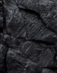 Black rock texture with cracks. Black stone background