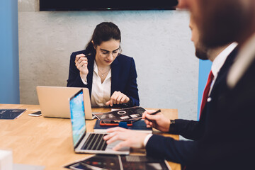 Serious businesswoman with colleagues working in office