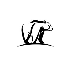 Sleek silhouette of a bear walking over a hill, minimalist style.