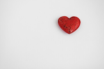 red heart made of fabric on a white background