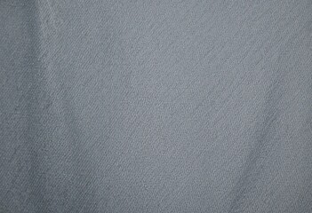 A close-up of a smooth, gray fabric with a tightly woven pattern. The material has a glossy finish and is likely used for outdoor gear such as jackets or backpacks due to its durability