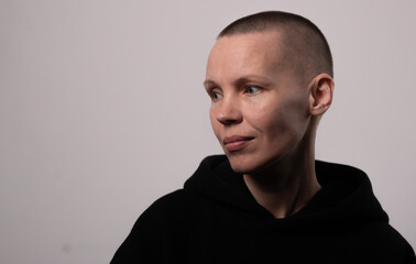 Thoughtful caucasian female adult with short hair in black top looking to side