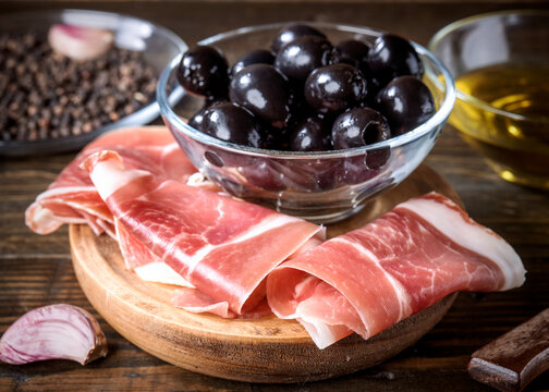 Delicious antipasto with spanish ham, black olives, and olive oil