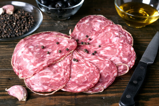 Slices of spanish salami with black pepper and garlic