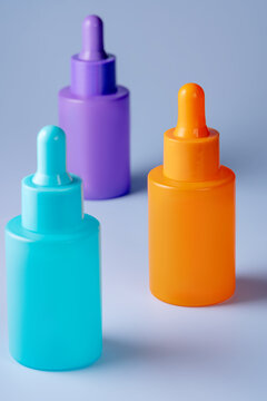 Colorful serum bottles on a light gray background