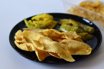 Fafda served on a black plate. A popular Indian snack from Gujarat