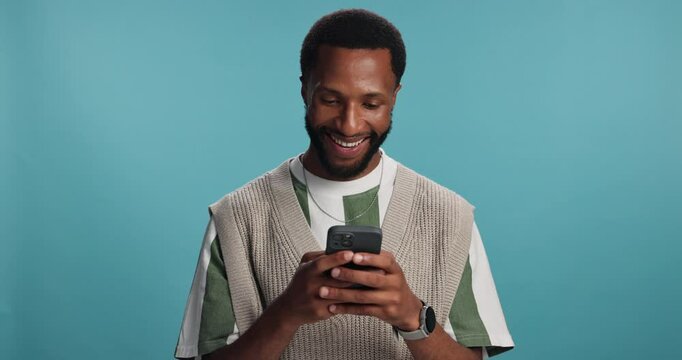 Studio, black man and happy with smartphone for chat, online meme and digital joke with contact. Mockup space, male person and social media with mobile app for comment, funny reel and blue background