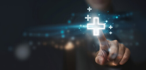 Businessman touching to plus sign mark for value added , It is symbol of business profit growth , health insurance , benefit and economy development concept.