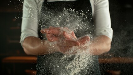 Fototapeta premium Freeze Motion Chef Clapping Hands with Flour . Closeup of Bread or Pizza Dough Preparation