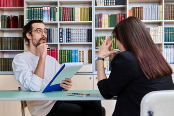 Young male mental health specialist working with mature female patient