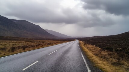 A tranquil isolated road glistening with raindrops beneath a dramatic, moody overcast sky