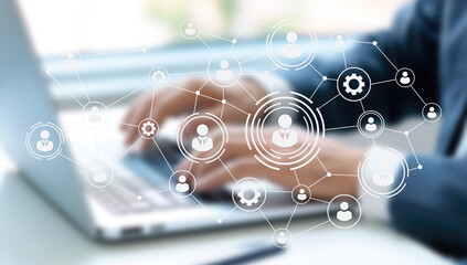 A modern workspace integrates digital tools and human elements, fostering collaboration among remote teams. The environment highlights flexibility, AI resources, and a focus on productivity