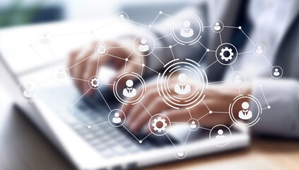 A modern workspace integrates digital tools and human elements, fostering collaboration among remote teams. The environment highlights flexibility, AI resources, and a focus on productivity