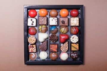 arranged selection of gourmet chocolates with various shapes and colors