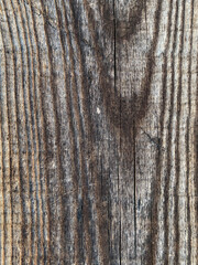 Obraz premium A close-up of aged wooden planks with deep cracks and natural grain patterns, showing a rustic texture