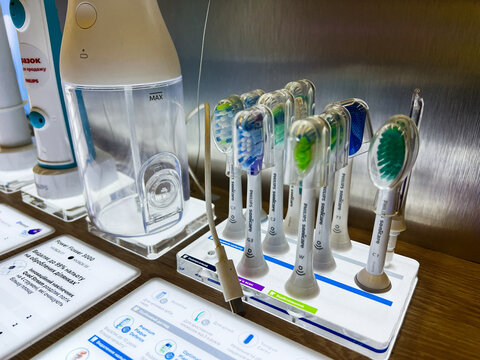 Kyiv, Ukraine - February 09, 2025: A showcase of different Philips Sonicare toothbrush head designs and an oral care device