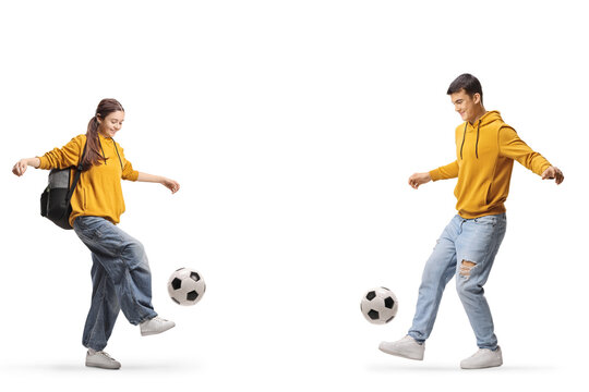 Male and female teenagers juggling with footballs