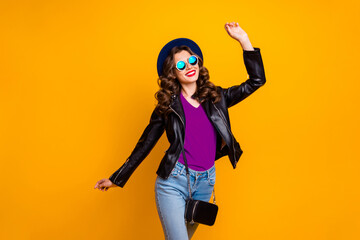 Photo of attractive lady walking down shopping center overjoyed by spring warm weather wear stylish outfit with shoulder clutch isolated yellow background
