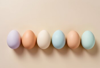 Pastel-colored eggs on beige background.