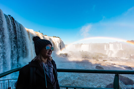 Woman tourist looking to the Iguazu Falls, border between Brazil and Argentina.
