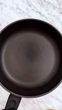 Toasting french baguette on frying pan