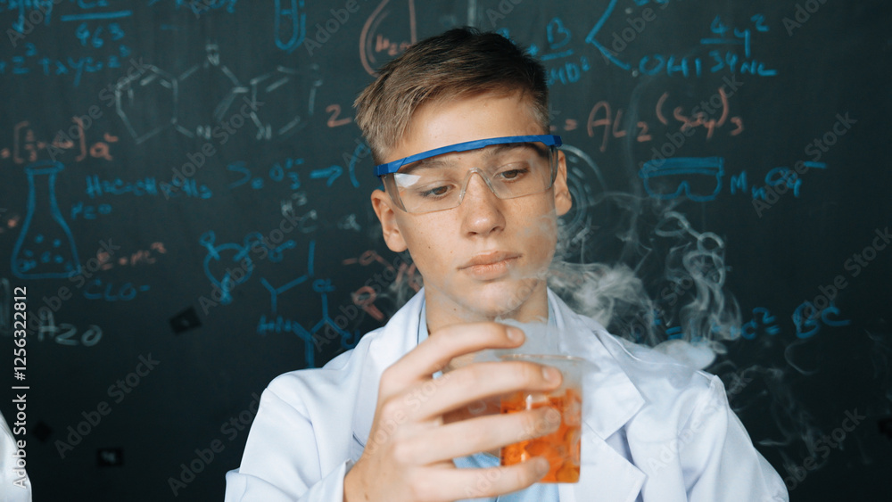 Poster closeup of boy inspect chemical solution while holding beaker at blackboard with chemical theory. sm
