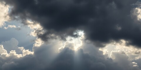 Fototapeta premium Light streams through dark clouds, representing hope and divine inspiration during Christian celebrations like Easter and Good Friday, evoking themes of renewal