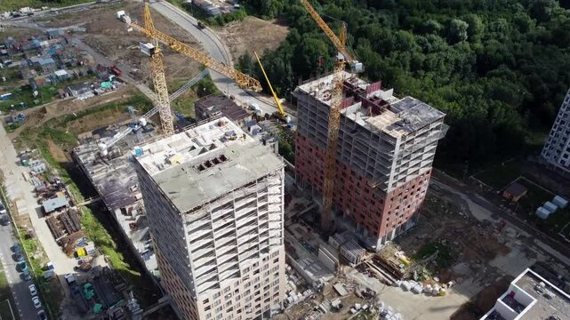 Moscow July 15 2022, Work boils at construction site: taps raise concrete slabs, workers lay reinforcement and pour concrete. PIK Group of Companies builds another high -rise building using modern