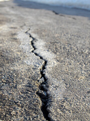 Crack in the pavement is shown in the image