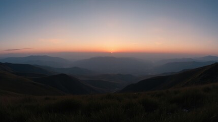 Fototapeta premium Serene Mountain Sunrise Overrolling Hills with Gentle Sky Colors