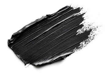 Smear of black paint creating a textured background on white surface, ideal for beauty and makeup projects