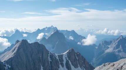 Fototapeta premium Stunning Mountain Range Under a Bright Blue Sky with White Clouds