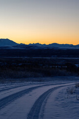 Orange sky behind mountains in Alaska