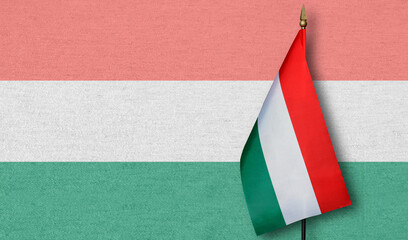 A small Hungary flag with a faint image of the Hungary flag in the background