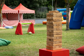 A big stack of wooden blocks in a kids playground, outdoors.
