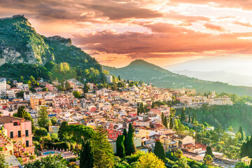 panoramic view of beautiful sunset in old european town with vintage buildings and great mountains...